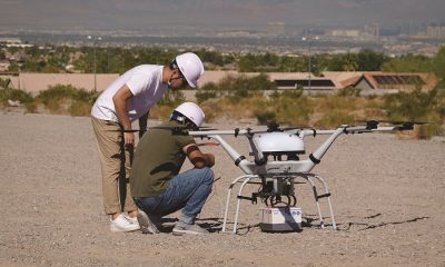 With the Las Vegas strip visible in the distance, a pair of technicians from South Korean conglomerate Doosan perform a final check on their aircraft prior to conducting a demonstration flight at the Commercial UAV Expo’s outdoor event.