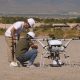 With the Las Vegas strip visible in the distance, a pair of technicians from South Korean conglomerate Doosan perform a final check on their aircraft prior to conducting a demonstration flight at the Commercial UAV Expo’s outdoor event.