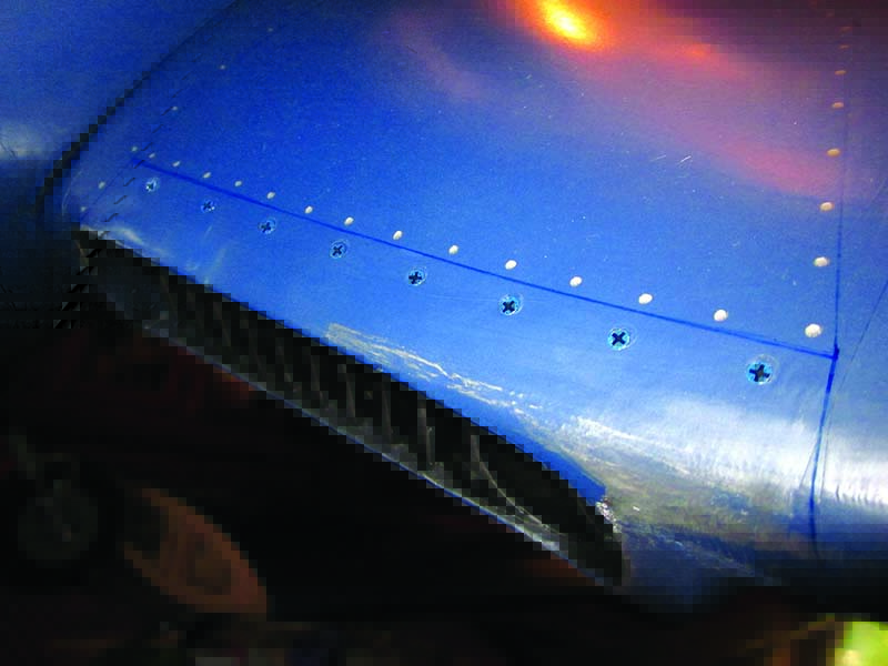 A typical place for screw heads is on the wing leading edge along the radiator inlet cover panels.