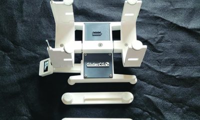 The contents of the box include the stand and digital scale and adapters for measuring different size wing chord models.